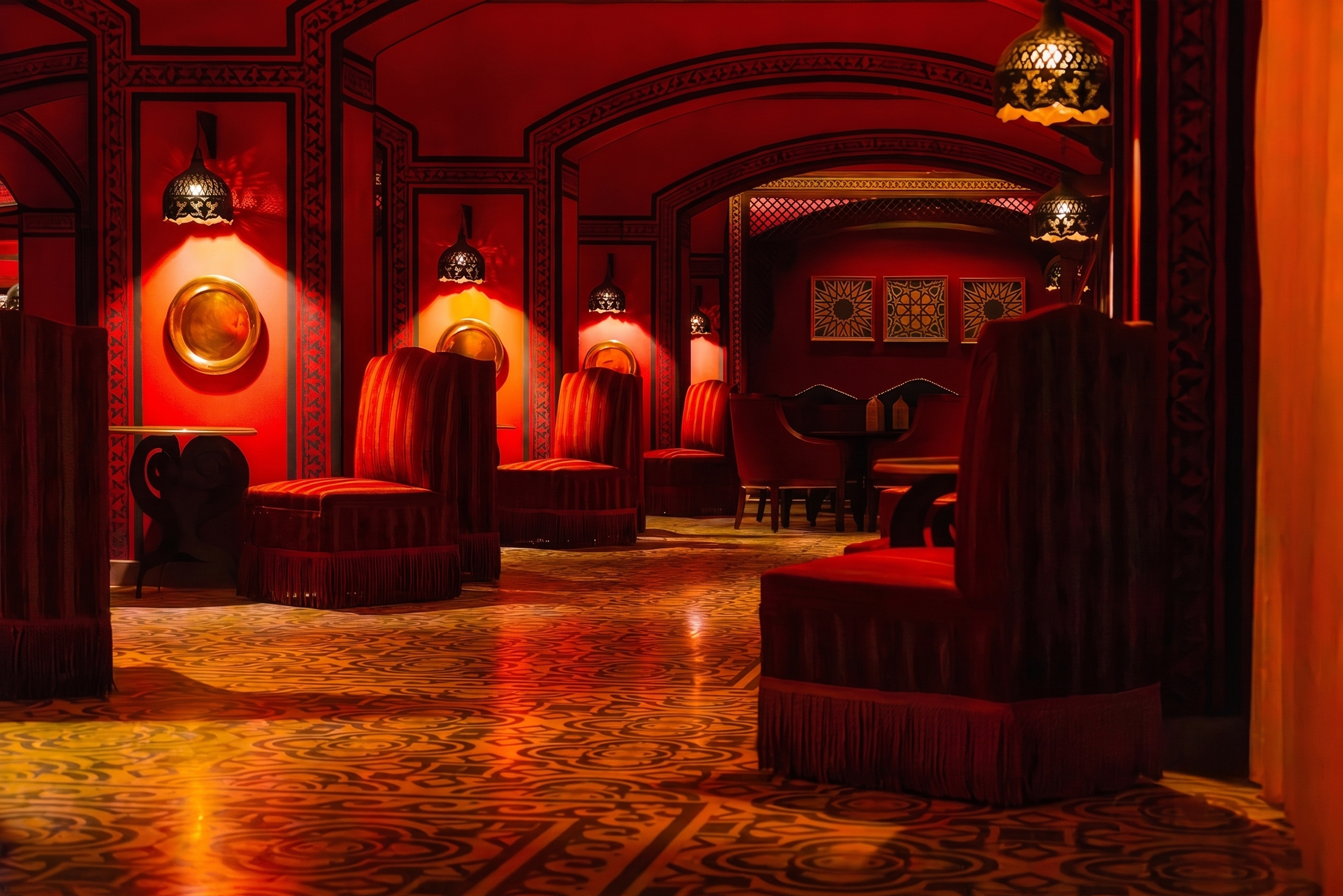 Luxurious oriental lounge interior with plush red velvet chairs, ornate floor tiles, and warm ambient lighting at Steigenberger Coraya Beach.