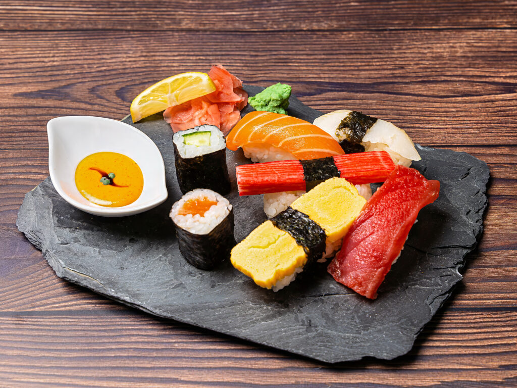 Sushi Platter Presentation Assorted sushi platter with salmon, tuna, and maki rolls artfully arranged on a slate board