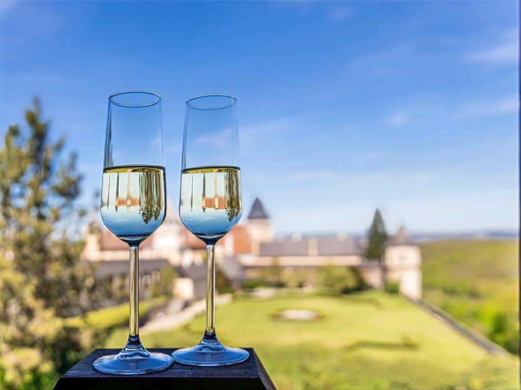Champagne Toast with Castle View (Hotel Bed Guide Crop) Champagne glasses with castle view, styled as a hotel turndown service moment